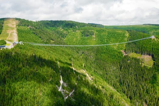 Aerial view of suspension Sky Bridge 721 and observation tower in mountains, Dolni Morava, Czech Republic.