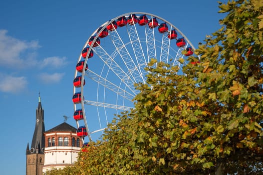 Wheel of vision and historic castle tower during sunset in Dusseldorf; Germany