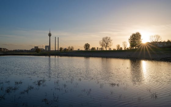 Sunset on the Rhine river with the cityscape of Dusseldorf in the background, Germany