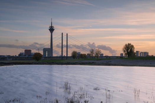 Sunset on the Rhine river with the cityscape of Dusseldorf in the background, Germany