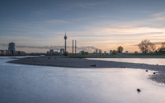 Sunset on the Rhine river with the cityscape of Dusseldorf in the background, Germany