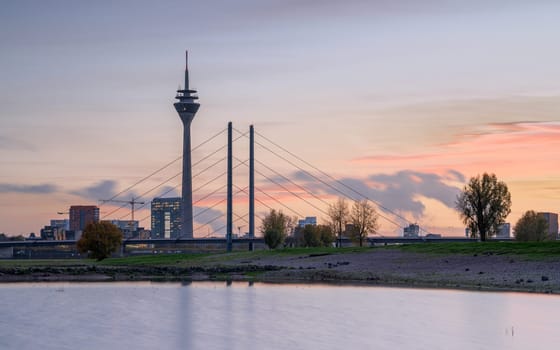 Sunset on the Rhine river with the cityscape of Dusseldorf in the background, Germany