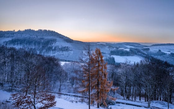 Panoramic image of winter landscape during sunrise, Schmallenberg, Sauerland, Germany