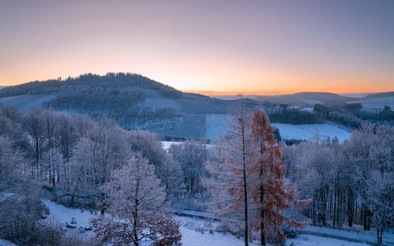 Panoramic image of winter landscape during sunrise, Schmallenberg, Sauerland, Germany