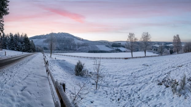 Panoramic image of winter landscape during sunrise, Schmallenberg, Sauerland, Germany