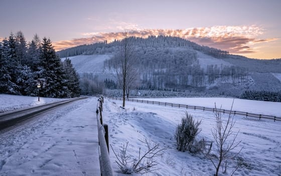 Panoramic image of winter landscape during sunrise, Schmallenberg, Sauerland, Germany