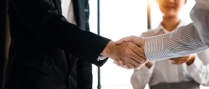 Businessmen making handshake with his partner - business etiquette, congratulation, merger and acquisition concept.