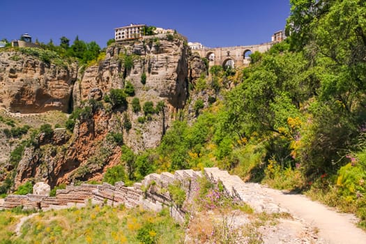 The massive rock wall at the famous bridge Puente Nuevo in the Andalusian city of Ronda in the province of Malaga, Spain