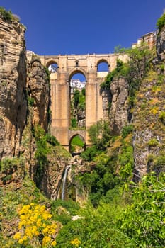 The striking Puente Nuevo bridge over the gorge in the town of Ronda in Andalusia in the sunshine, Spain