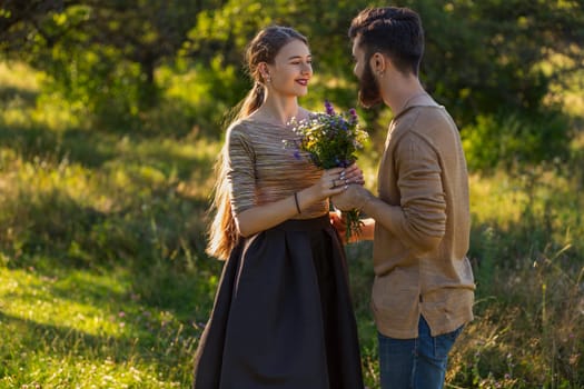 man giving wild flowers to his girlfriend