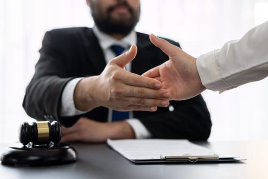 Closeup lawyer or attorneys colleagues handshake after successful legal discussing on contract agreement for lawsuit to advocate resolves dispute in court ensuring trustworthy partner. Equilibrium