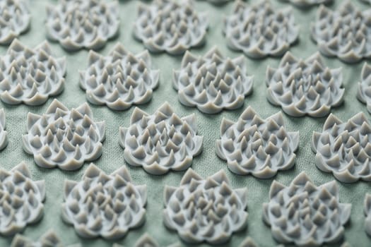 Sewing mother-of-pearl pins in a round white package on a blue background with free space