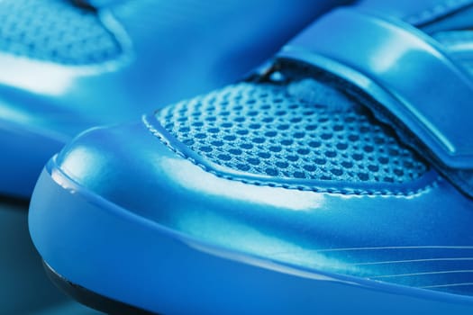 Blue Shiny Bicycle Shoes for Road Bike on Blue Background