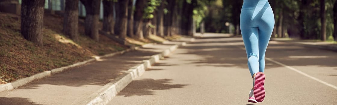 Beautiful fit young woman jogger is running outdoors