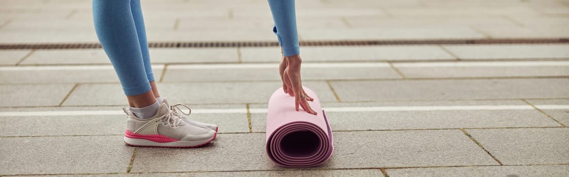 Young fit lady is doing fitness and jogging at urban place