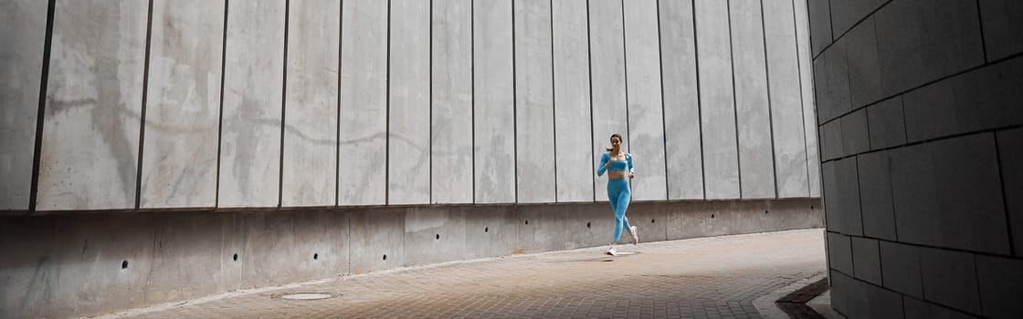 Beautiful fit young woman jogger is running outdoors