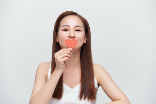 Asian woman with red heart on white background