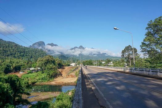 The destination of the road is a foggy mountain road to Pilok Village, Kanchanaburi Province, Thailand.