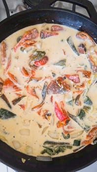 Rajas con crema, poblano chili peppers with cream in cooking pan. Mexican vegetarian food in Baja California.