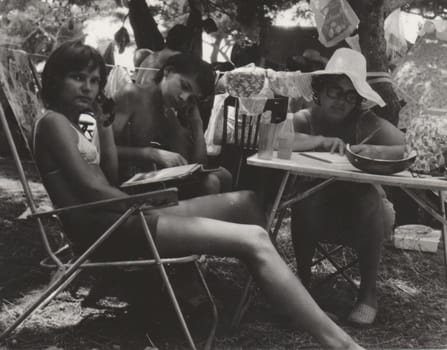 THE CZECHOSLOVAK SOCIALIST REPUBLIC - AUGUST 1977: Vintage photo shows people in the summer time. Retro black and white photography. Circa 1980.