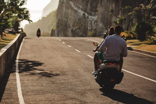 the girl is driving a scooter. bali