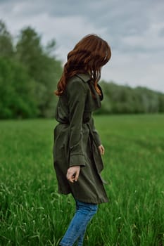 a woman with long red hair stands in a field in tall green grass. High quality photo