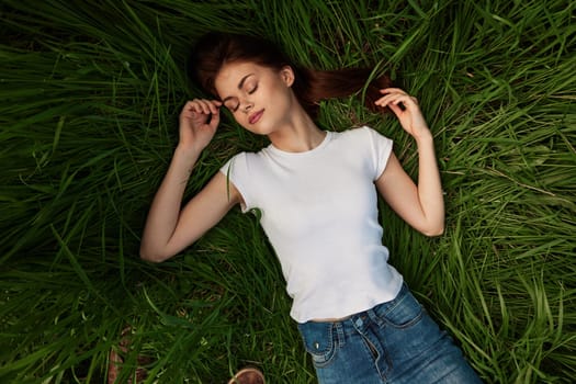 woman dreaming lying on the grass . High quality photo