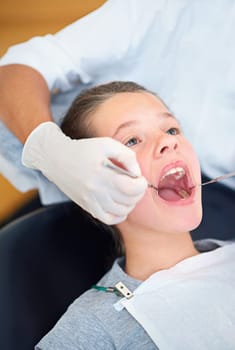 I think you need a filling. Closeup shot of a young girl having a checkup at the dentist