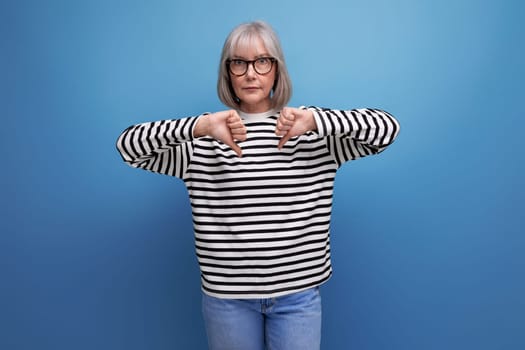 successful mature woman with gray hair on bright studio background.