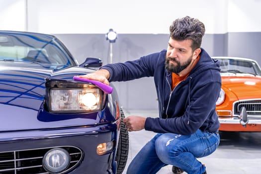 manual cleaning of the exterior of an old car. High quality photo