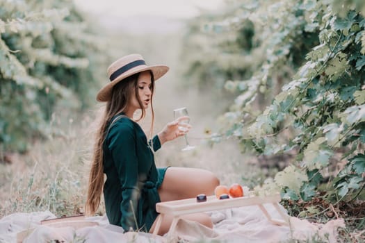 Picnic and wine tasting at sunset in the hills of Italy, Tuscany. Vineyards and open nature in the summer. Romantic dinner, fruit and wine.