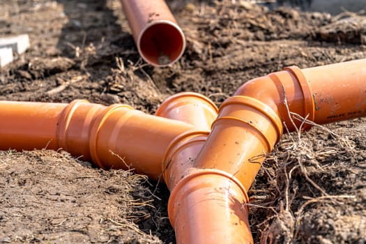 orange PVC plastic pipes on the construction site.