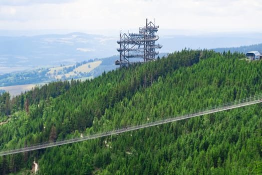 Sky walk observation tower in the forest between mountain hills near Sky Bridge 721 in a sunny summer day, Dolni Morava, Czech Republic.