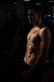 Shirtless man with sculpted body in the gym