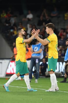 MELBOURNE, AUSTRALIA - MARCH 28: Jordan Bos of Australia subs with Aziz Behich during an international friendly match between the Australia Socceroos and Ecuador at Marvel Stadium on March 28, 2023 in Melbourne, Australia.