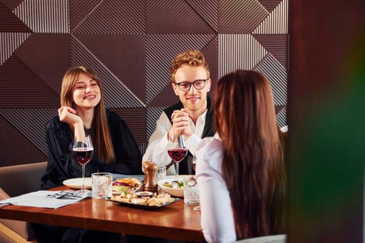 Having conversation. Indoors of new modern luxury restaurant.