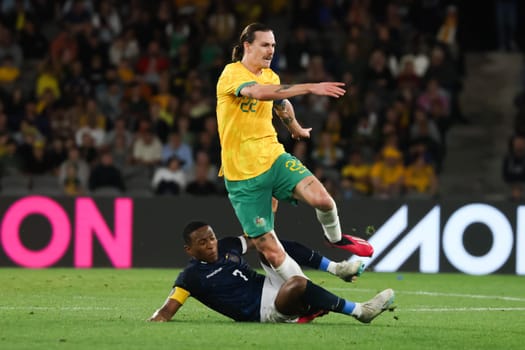 MELBOURNE, AUSTRALIA - MARCH 28: Jackson Irvine of Australia battles with Pervis Estupiñán of Ecuador during an international friendly match between the Australia Socceroos and Ecuador at Marvel Stadium on March 28, 2023 in Melbourne, Australia.