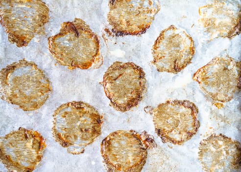 Close-up macro shot of cooking paper with greasy prints left by fried meatballs, creating appetizing and savory texture that represents frizzling cooking concept. Brown circles adds rustic and homemade feel. High quality photo