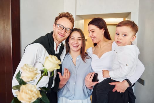 Two women, guy, and little boy. Indoors of new modern luxury restaurant.