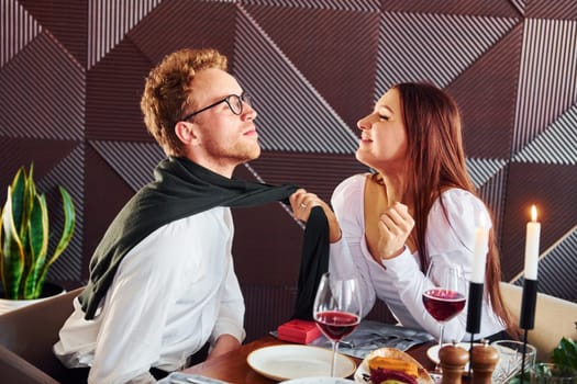 Couple of young guy and adult woman. Indoors of new modern luxury restaurant.