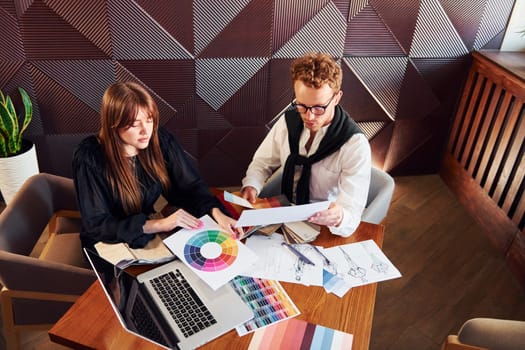 Business people working with documents. Indoors of new modern luxury restaurant.