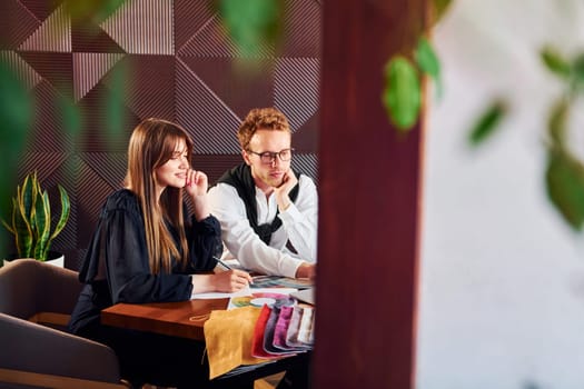 Business people working with documents. Indoors of new modern luxury restaurant.