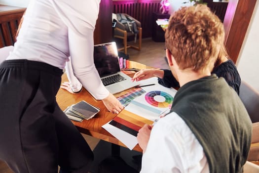 Creative work. Group of people. Indoors of new modern luxury restaurant.