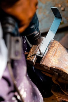 Image of Metalworker working on a drilling machine