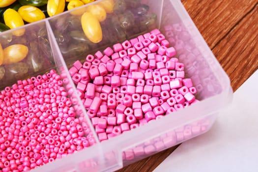 Colorful beads in containers close up, handicrafts, macrophoto