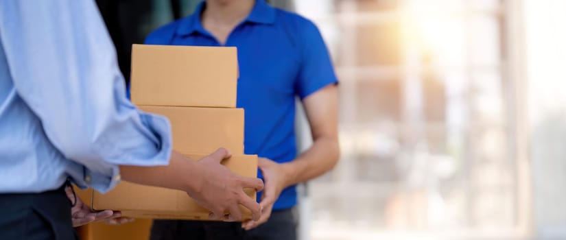 Home delivery service and working service mind. Man customer hand receiving a cardboard boxes parcel from delivery service courier. delivery logistic concept.