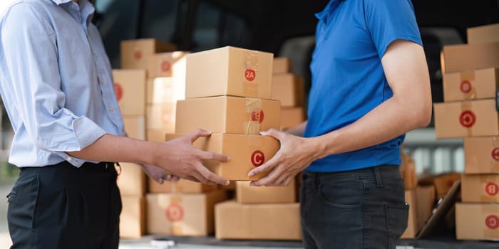 Home delivery service and working service mind. Man customer hand receiving a cardboard boxes parcel from delivery service courier. delivery logistic concept.