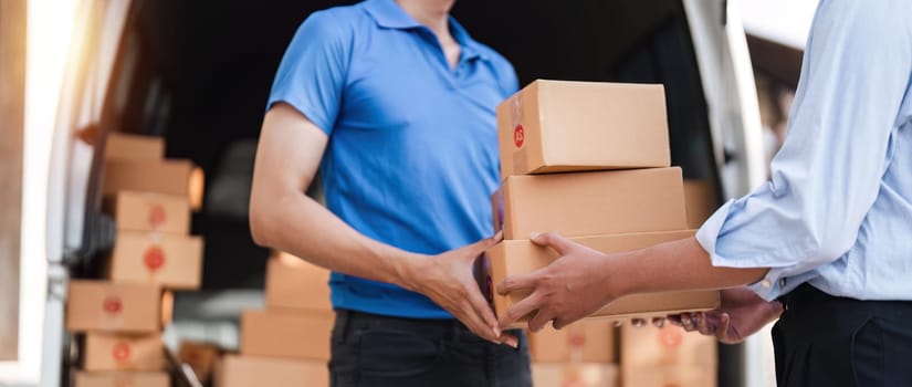 Home delivery service and working service mind. Man customer hand receiving a cardboard boxes parcel from delivery service courier. delivery logistic concept.