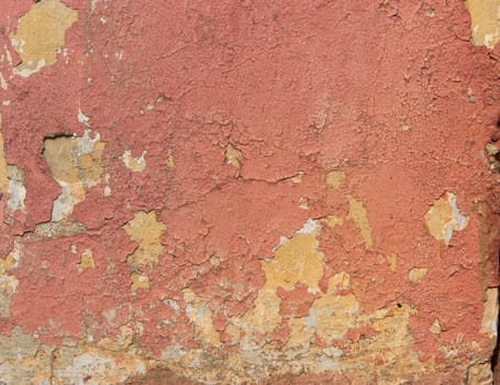 Old concrete wall with crumbling paint and yellow paint, backgrounds, textures
