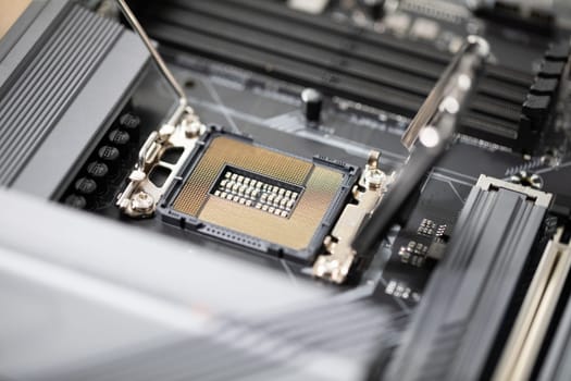 Replacing computer parts. Close-up of the computer motherboard. Laptop repair by a professional. Replacement of computer parts to improve the quality of use.